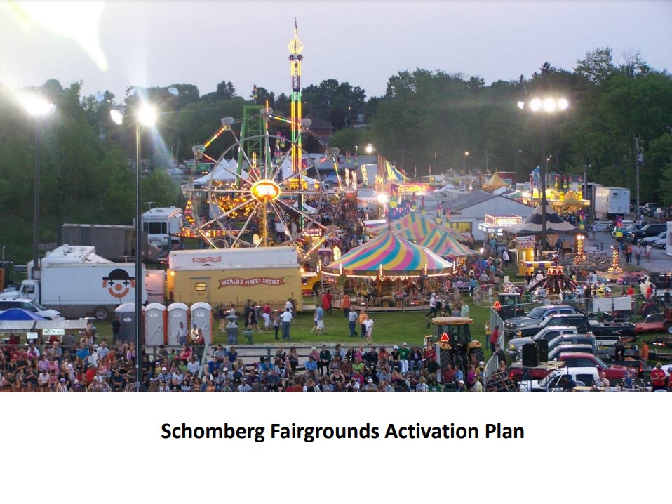 image of busy fariground with farirswheel in the background