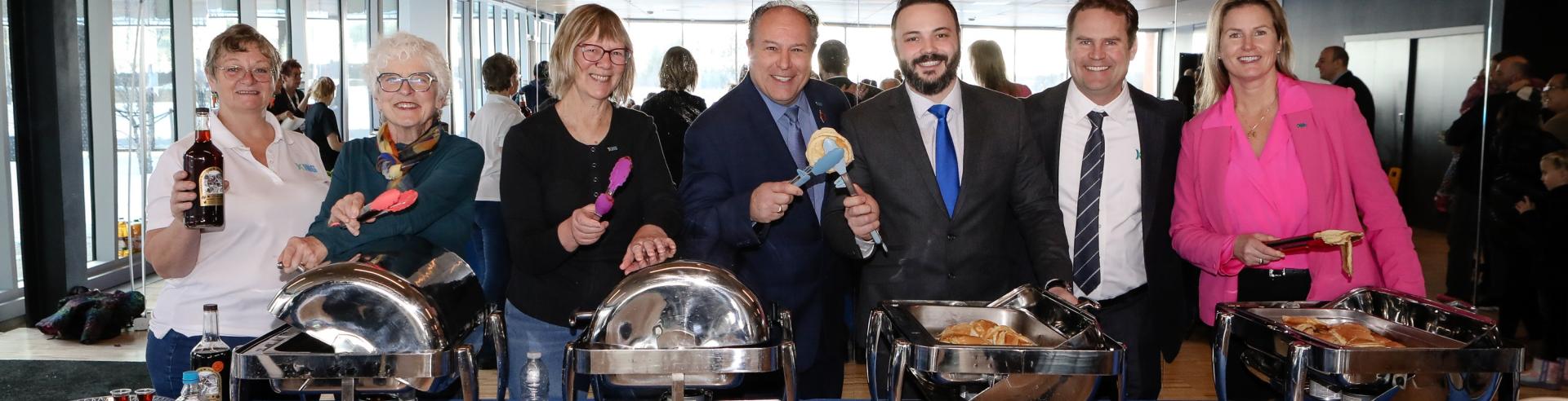 Mayor and Council serving breakfast food