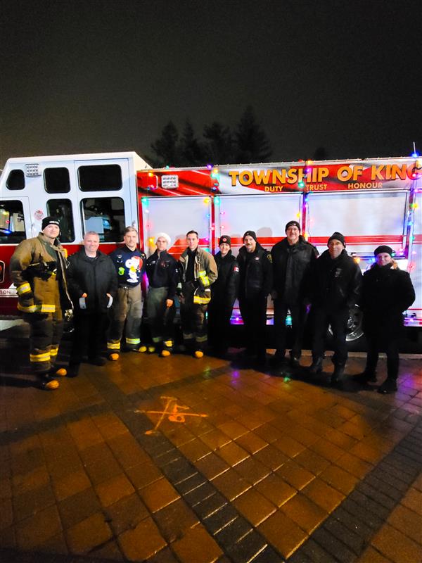 Firefighters gathered around firetruck