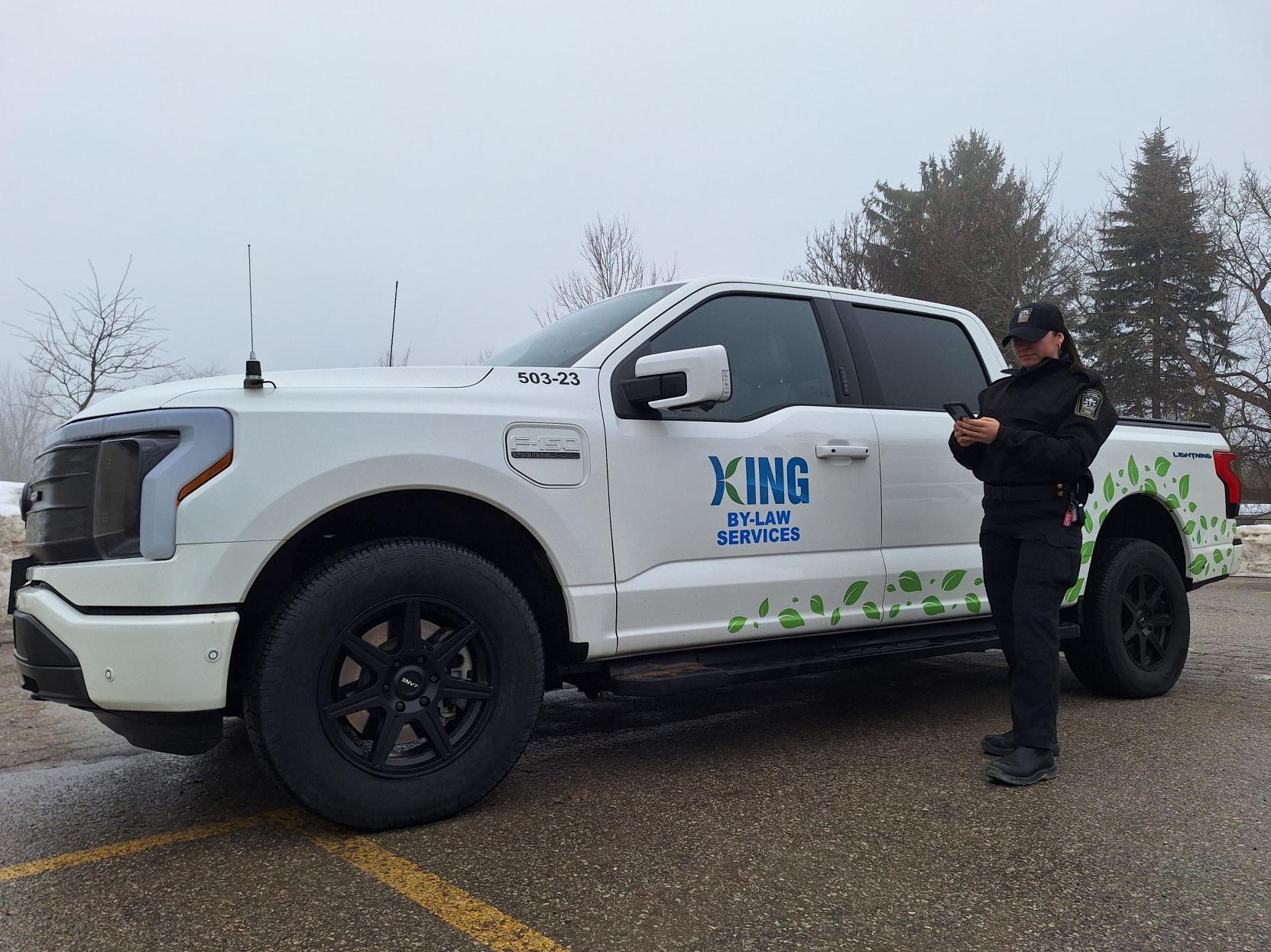 King Township By-law Officer working on phone